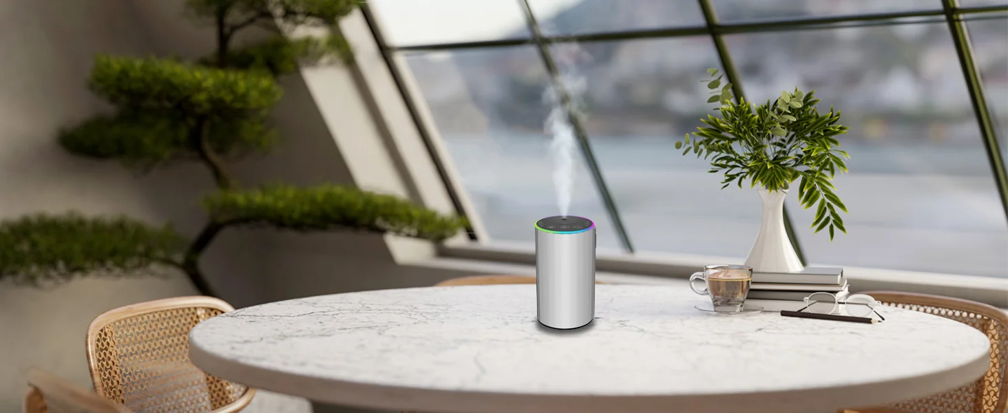 Silver 2452 waterless essential oil diffuser on a marble table with indoor plants - quiet home fragrance lifestyle scene